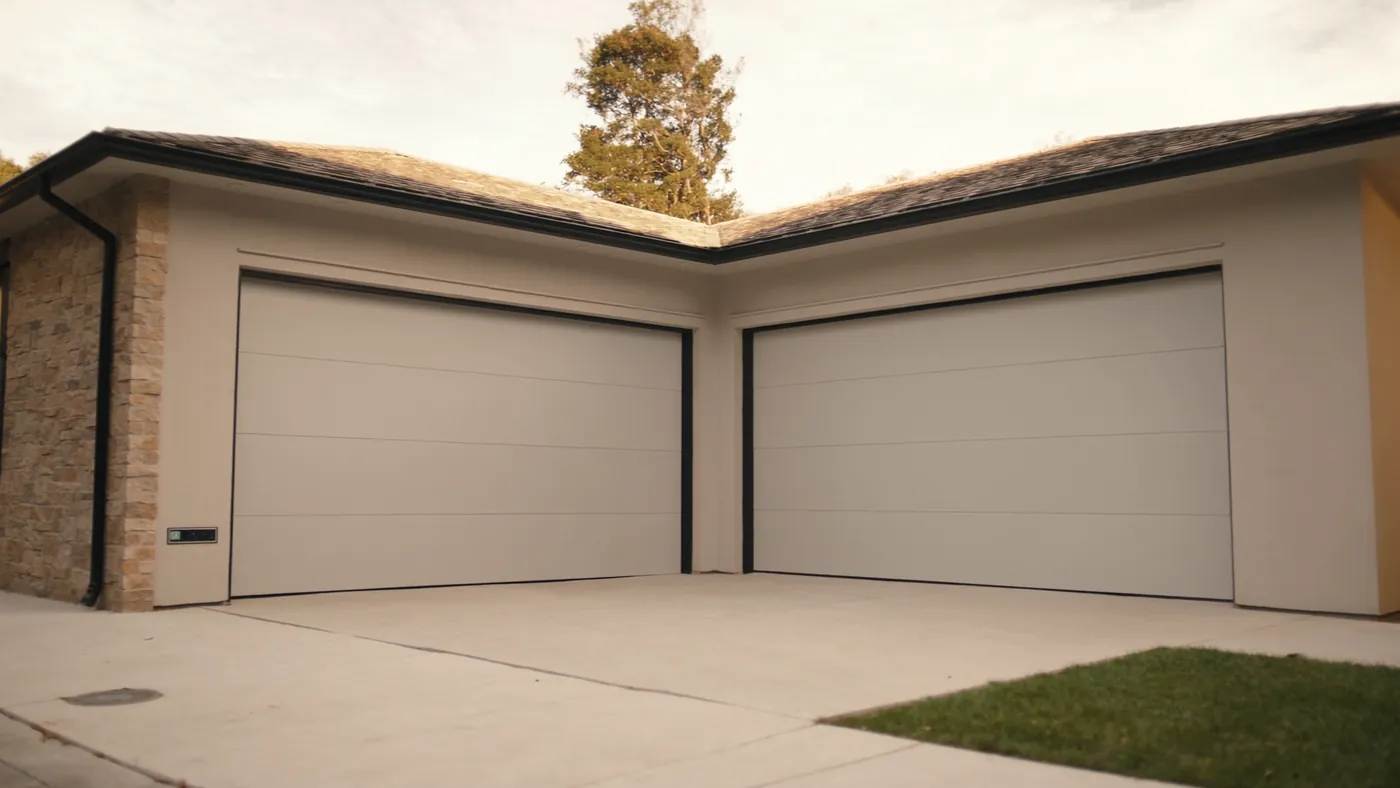 A modern home with a brand new sectional garage door and clean driveway