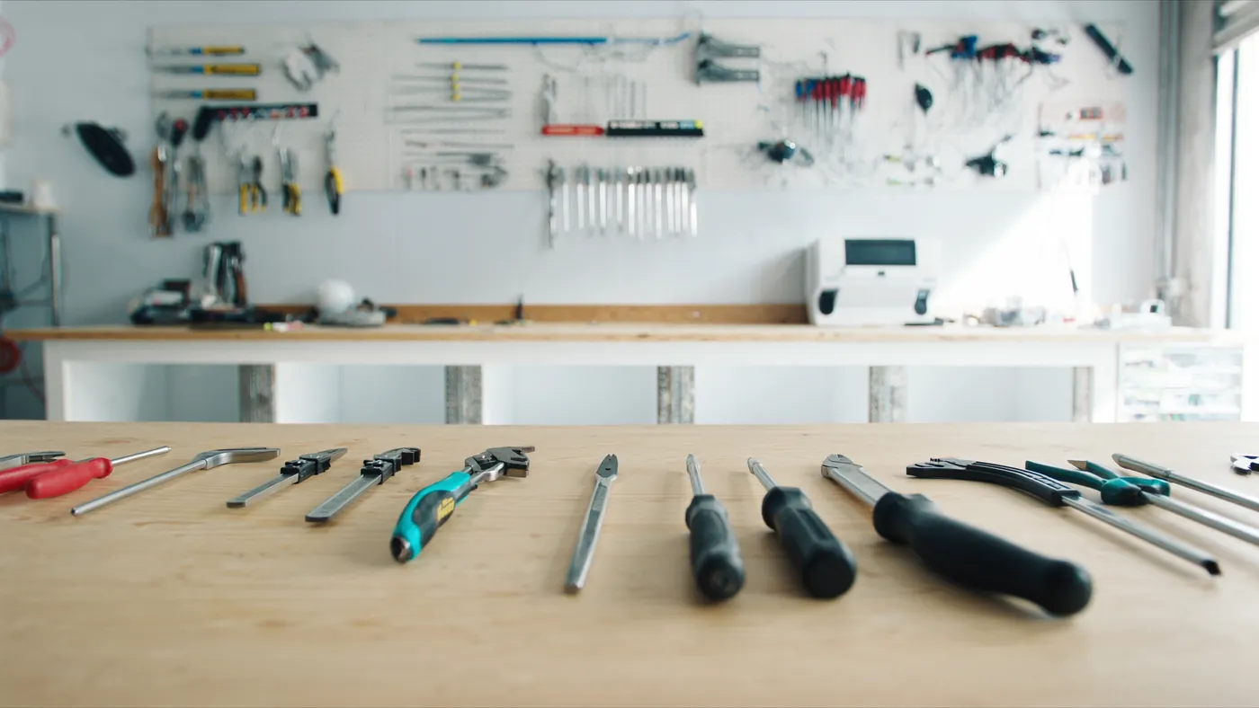Quality hand tools laid out on a clean workbench in a bright workshop