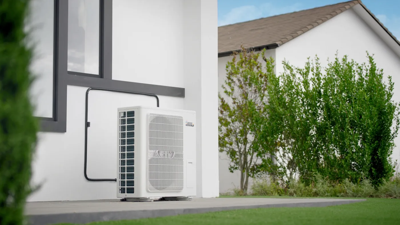 A new high efficiency HVAC unit freshly installed beside a modern home