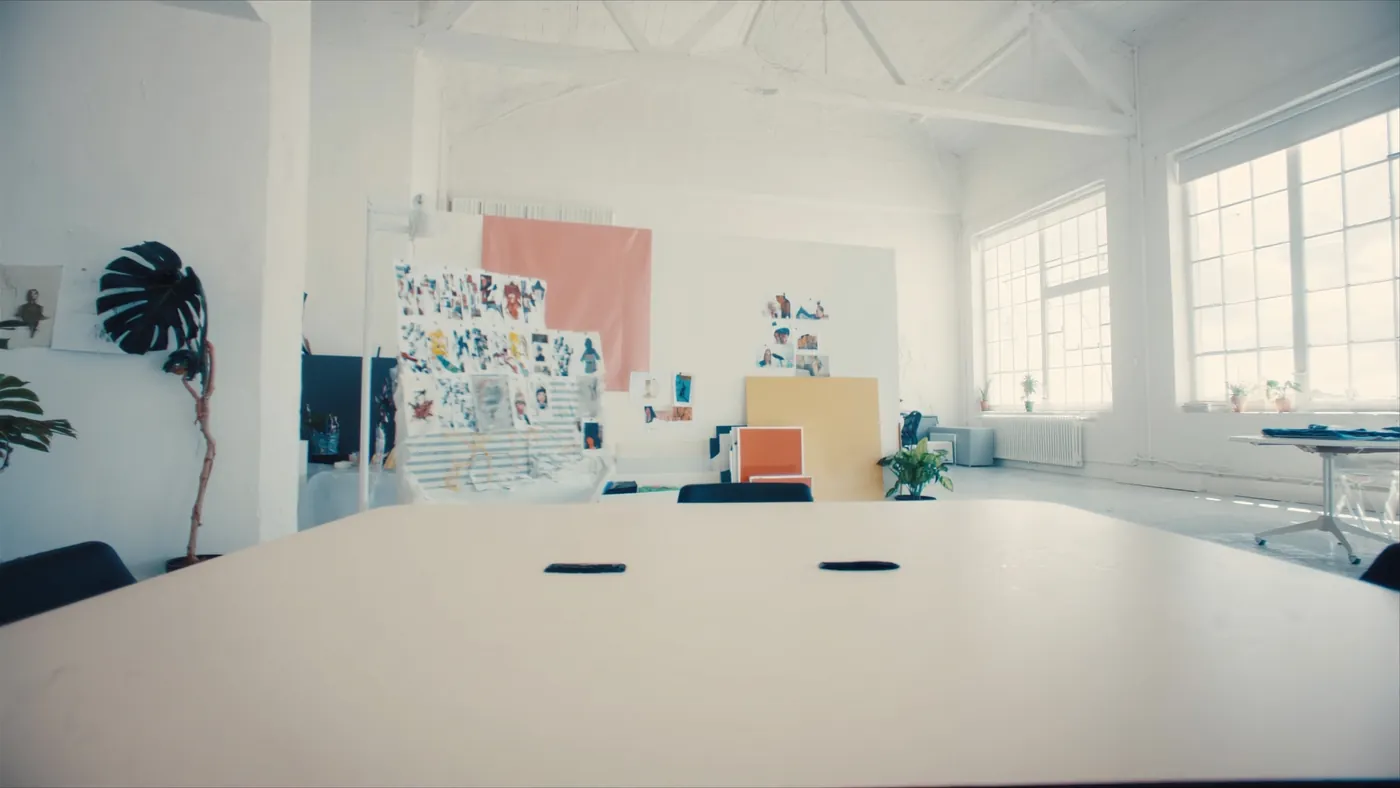 A modern creative agency studio with a clean collaborative table in a bright loft